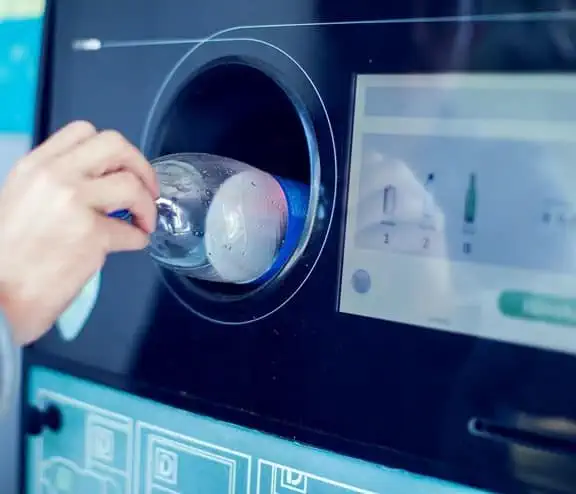 Bottle being inserted into vending machine