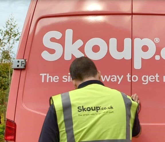 Worker in front of Skoup van doors
