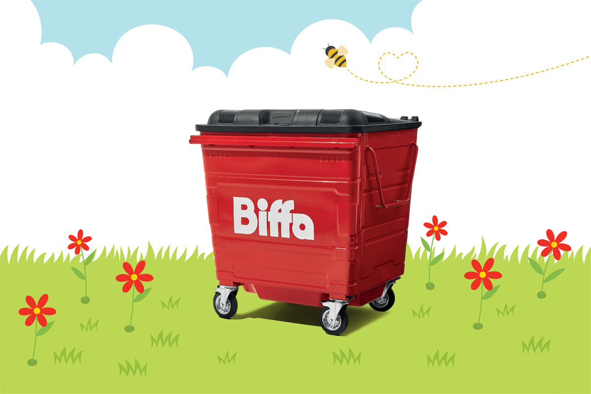 Biffa bin in grass with red flowers