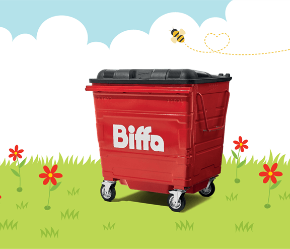 Biffa bin in grass with red flowers