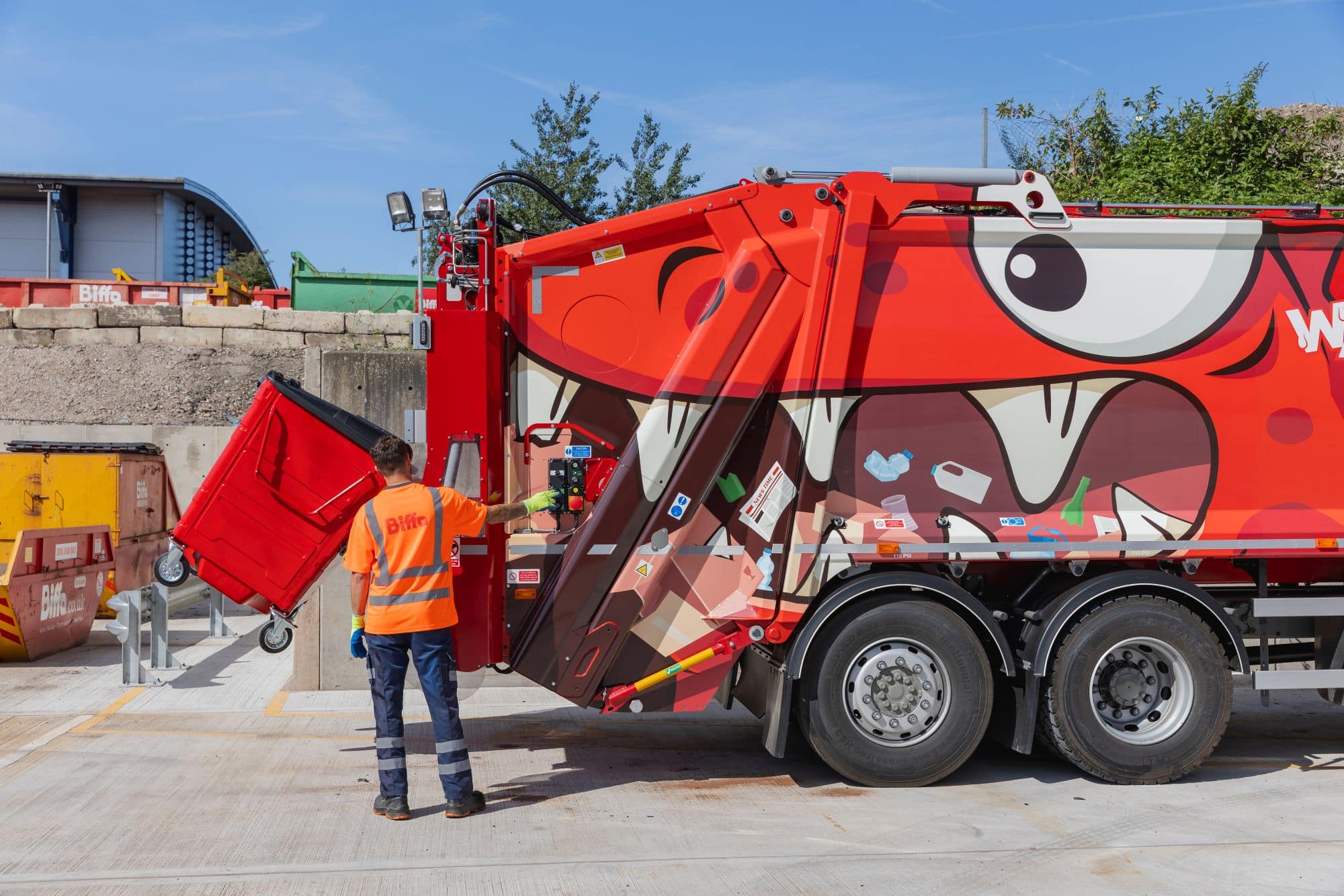 Employee loading bin into the back of truck