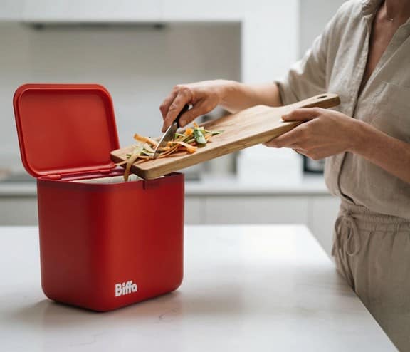 Food getting scrapped into red food caddy