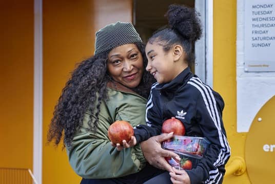 Women and child with fruit