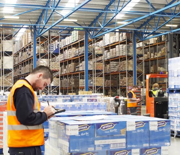 Worker in front of pallet boxes