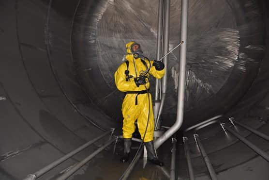 Man in hazmat suit cleaning