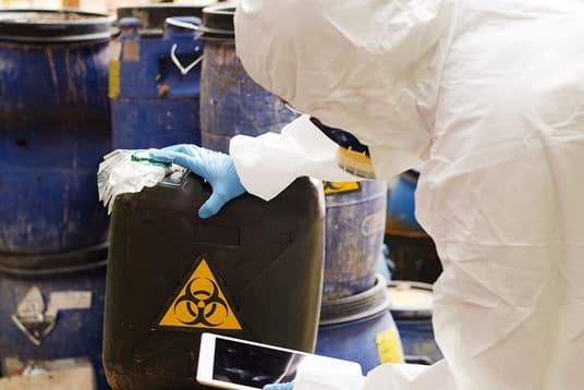 Person in hazmat suit with ipad