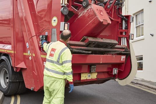 Biffa worker emptying bin in lorry