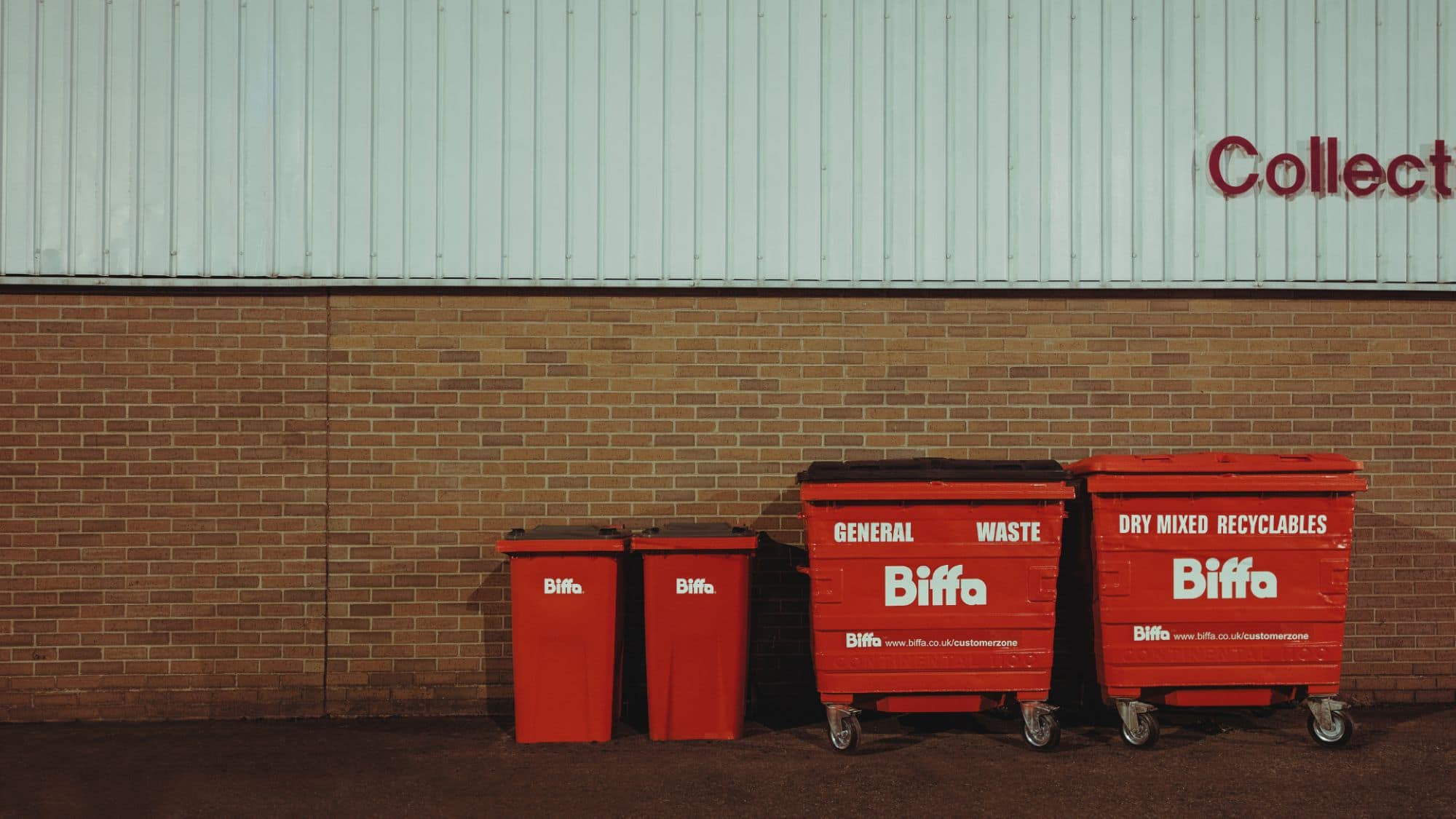 Bins lined up in front of wall