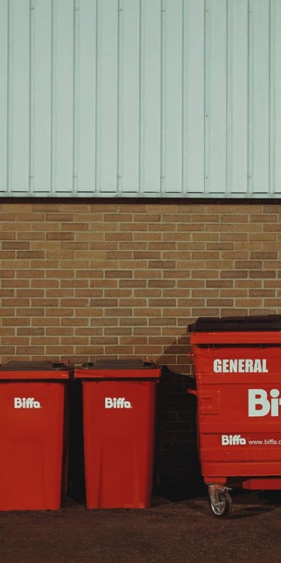 Bins lined up in front of wall