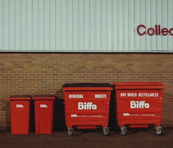 Bins lined up in front of wall