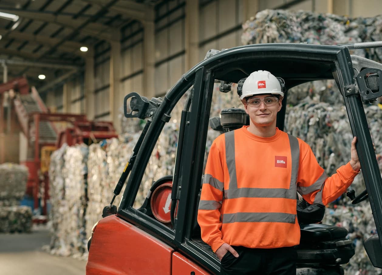 Biffa employee standing next to forklift