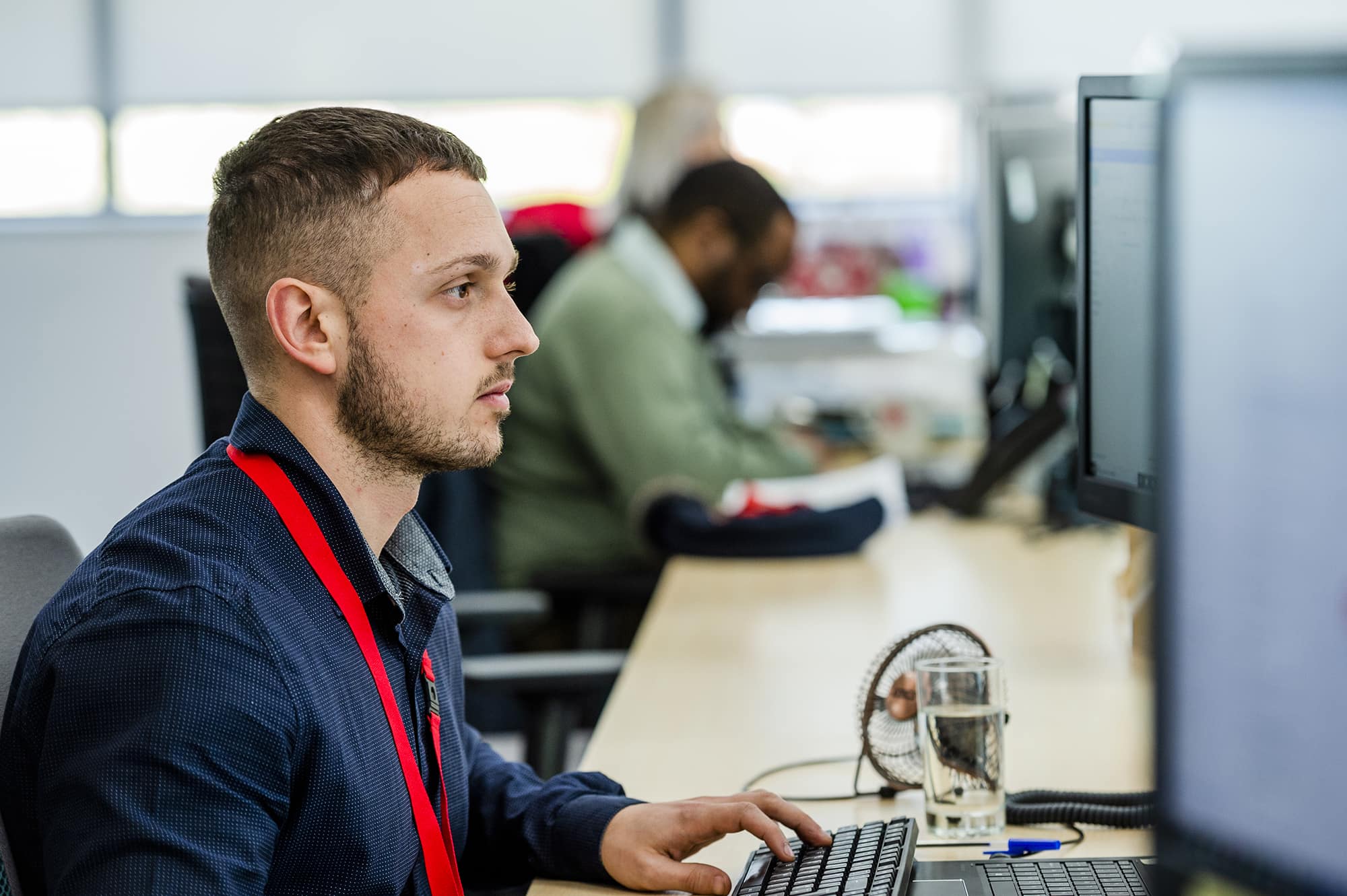 Biffa employee at desk looking at monitor