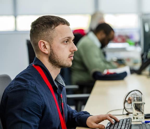 Biffa employee at desk looking at monitor