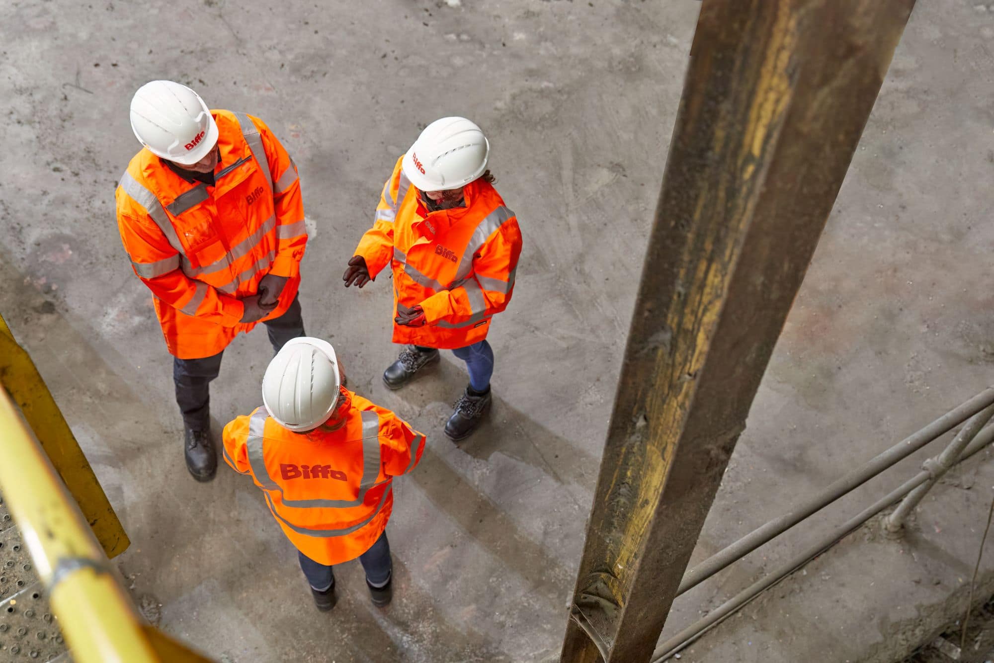 3 employees standing talking