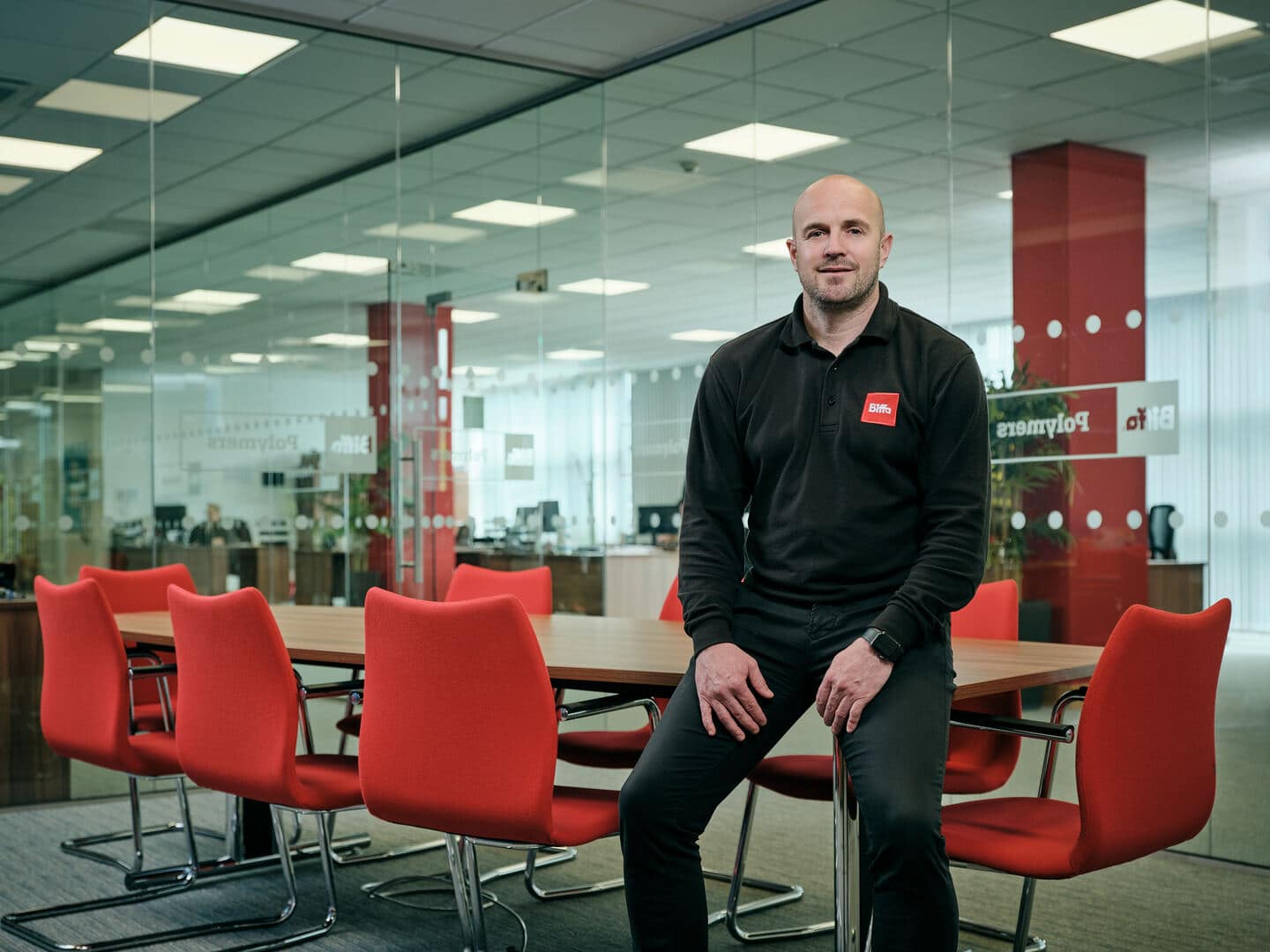 Male employee sitting on office desk