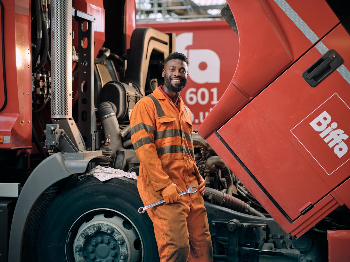 Male employee in Biffa overalls with spanner in hand