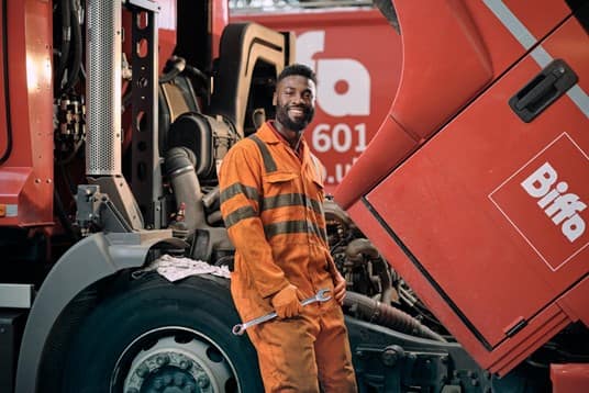 Male employee in Biffa overalls with spanner in hand