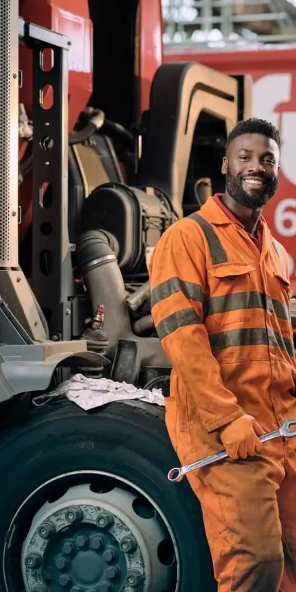 Male employee in Biffa overalls with spanner in hand