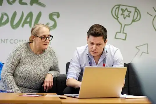 Members of ISS working together to help social enterprise Community Shop apply for employment roles with ISS