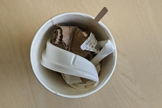 coffee cup with scrunched lid, exterior card and stick inside