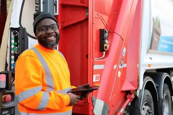 Employee smiling in front of a Biffa truck