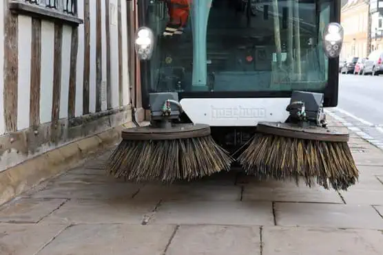Street sweepers on pavement