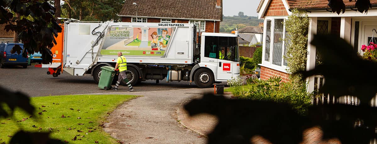 Biffa municipal collection behind leaves