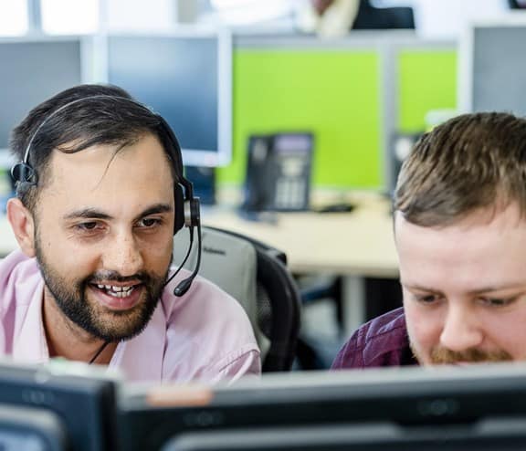 Two male employees with headsets