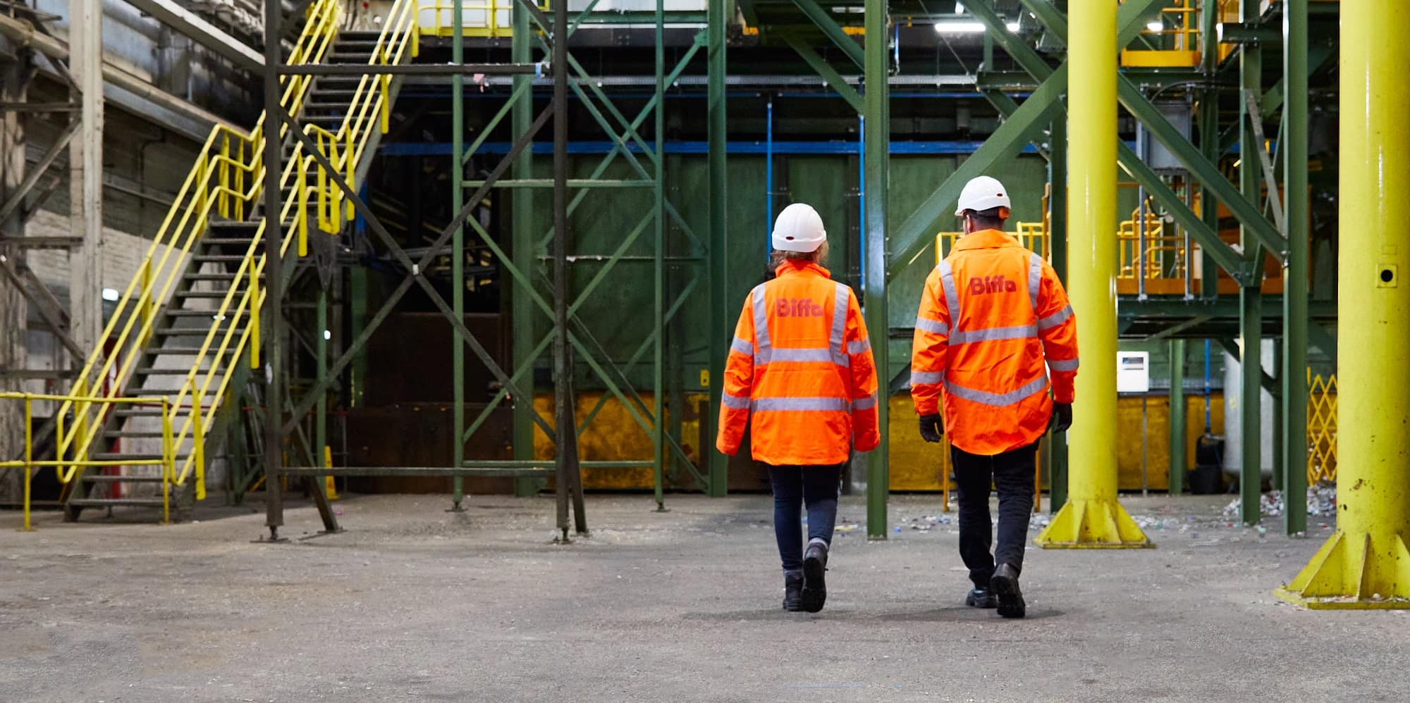 Back of two employees with Biffa high vis