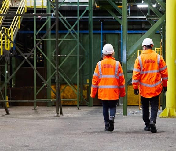 Back of two employees with Biffa high vis