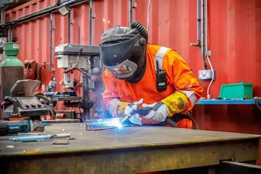Man from Biffa welding inside a waste factory