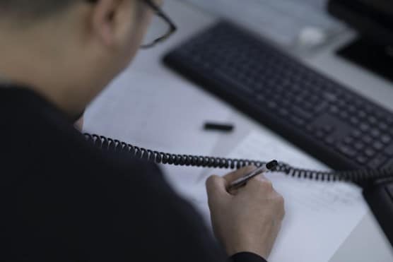 Man helping customer on phone to guide them through regulatory requirements