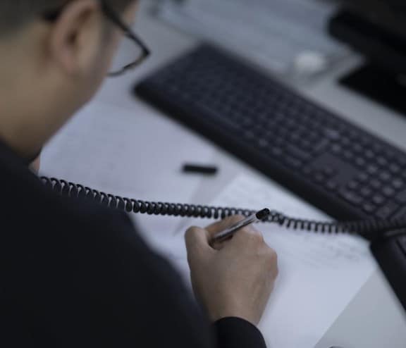 Man helping customer on phone to guide them through regulatory requirements