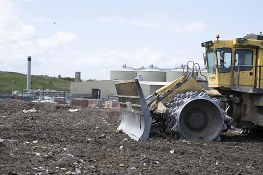 Front end loader disposing waste safely which can't be recycled