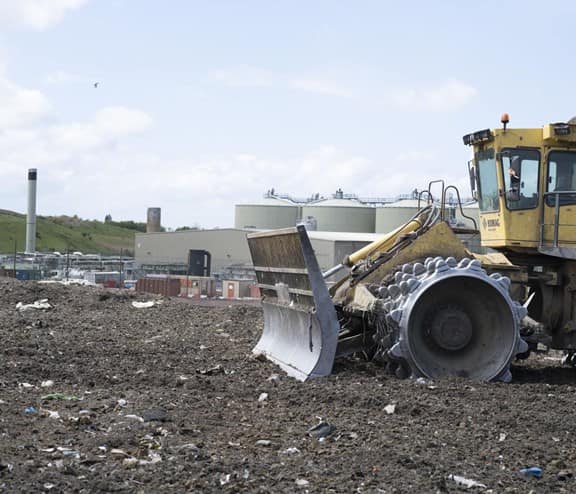 Front end loader disposing waste safely which can't be recycled