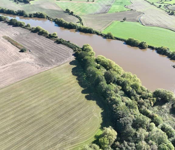 Birds eye view of a river and fields