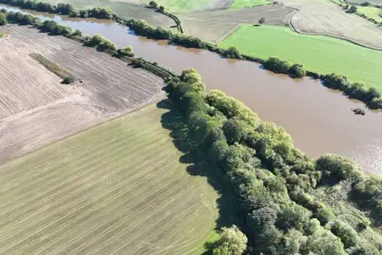 Birds eye view of a river and fields