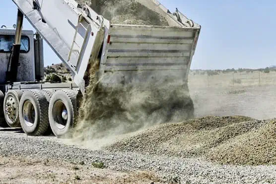 Truck offloading aggregate material