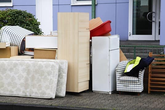 Multiple household items outside building