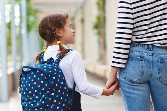 Girl holding mothers hand